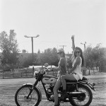 Devon Orr and Danielle Rothwell on a vintage Triumph dual sport motorcycle