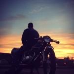 Jeff Wolf, observing the sunset on motorcycle